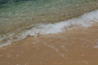 Kaboompics - Gentle White Wave Rolling Across Sandy Shore