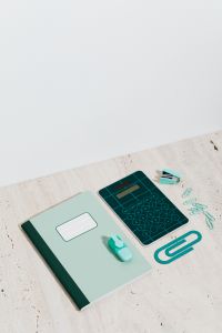 Kaboompics - Notebook, Calculator, Pencil and Eraser on Beige Stone for Homework and Classroom Study