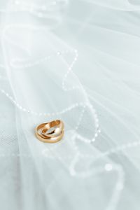 Kaboompics - Golden rings on a white veil