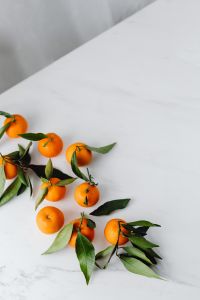 Kaboompics - Mandarins with Green Leaves on Marble, Minimal Vertical Background for Citrus Recipe Covers