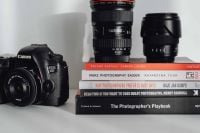 Kaboompics - Photographer's desk - books, DSLR camera and lenses