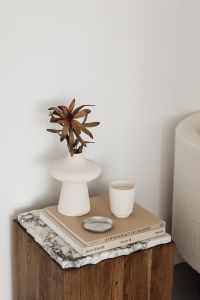 Kaboompics - Neutral Home Decor Detail with Sculptural Vase, Ceramic Cup and Art Books