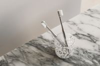 Kaboompics - Close-Up of Toothbrushes in a Patterned Glass beside Diagonal Marble Veining