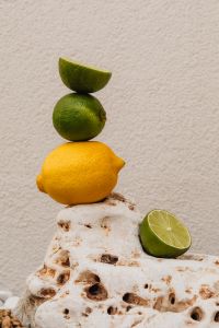 Kaboompics - Stacked Lemon and Limes on Textured Natural Stone