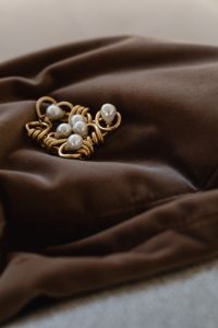 Kaboompics - Brown Satin Jewelry Background with Gold Wire and Pearl Embellishments, Copy Space