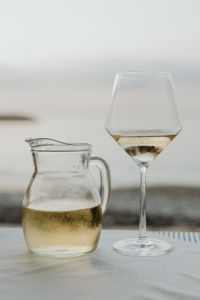 Kaboompics - White Wine Decanter and Glass on a Bright Minimal Background