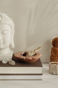 Kaboompics - White Buddha Bust With Smudge Bowl And Wooden Buddha