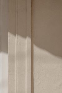 Kaboompics - Minimal Cream Stucco Wall with Angular Sunlight and Copy Space