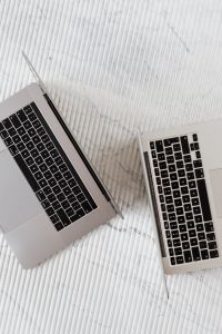 Kaboompics - Vertical Overhead View of Two Silver Laptops on White Ribbed Surface