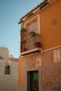Kaboompics - Orange Malaga House with Potted Balcony Plants