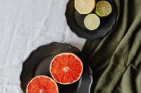Kaboompics - Close-Up Red Grapefruit Halves and Lemon-Lime Plate, Colorful Fresh Fruit Editorial