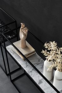 Kaboompics - Wooden Hand Sculpture, Books and White Ceramic Vases on a Black Marble Shelf