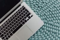 Kaboompics - MacBook Laptop on a blue pouf