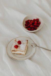 Kaboompics - Overhead Napoleonka Slice with Raspberries, Bowl and Dessert Fork