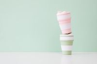 Kaboompics - Pink and Sage Green Collapsible Cups Styled as Space-Saving Travel Drinkware