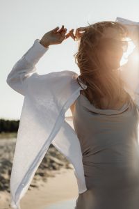 Kaboompics - Faceless Woman Standing at Waterline in White Shirt