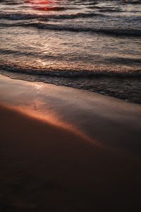 Kaboompics - Orange Sunset Reflection on Wet Shoreline