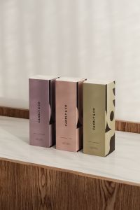Kaboompics - Three Neutral Fragrance Packaging Boxes on Display