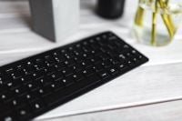 Kaboompics - Close-Up Black Keyboard and Glass Vase on White Desk