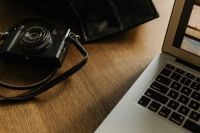 Kaboompics - Camera and Laptop Arranged on Wooden Home Office Desk