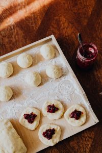 Kaboompics - Pączki Dough and Cherry Jam on a Dark Wooden Table