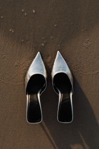 Kaboompics - Silver High Heels with Long Shadows on Minimal Beach Sand