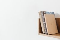 Kaboompics - Neutral Design Books on a Floating Wooden Shelf, Close-Up