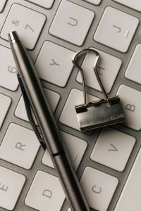 Kaboompics - Black Pen and Binder Clip on White Keyboard