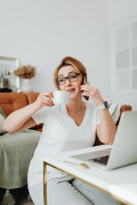 Kaboompics - Coffee and Customer Call: Woman Working from Home with a Smartphone