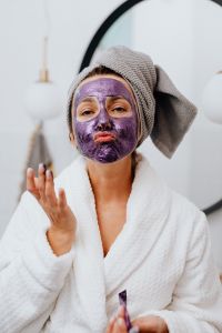 Kaboompics - Playful Beauty Portrait of a Woman in a Towel Wrap and Purple Face Mask