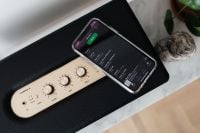 Kaboompics - Black speaker on marble table, white wall, mobile phone