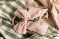 Kaboompics - Pastel Fabric Bow Hair Tie On Green Gingham Fabric