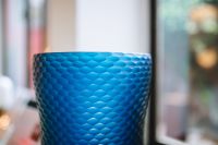 Kaboompics - Side View of a Blue Geometric Glass Vase with Faceted Texture
