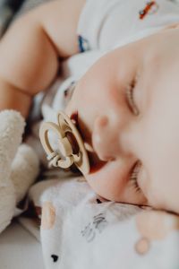 Kaboompics - Sleeping Newborn with Pacifier and Soft Toy Close-Up