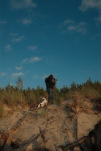 Kaboompics - Photographer on a Sand Dune Capturing the Sunset