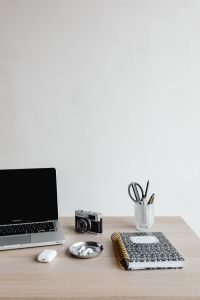 Kaboompics - Minimal Workspace with Laptop, Camera, AirPods and Notebook