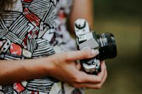 Kaboompics - Woman in a dress with a camera
