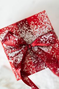 Kaboompics - Top-Down Red Christmas Gift Box with a Sparkling Snow-Dusted Ribbon