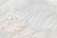 Kaboompics - White Skincare Foam Sweep with Bubble Clusters and Diagonal Lather Streaks