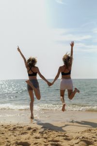 Kaboompics - Women Jumping and Holding Hands by the Ocean