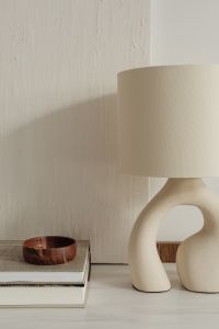 Kaboompics - Close-Up of a Sculptural Table Lamp and Wooden Bowl on Design Books
