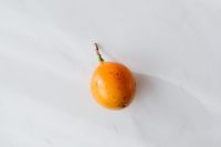 Kaboompics - Single Passion Fruit on White Marble for Healthy Food Menus and Editorial Layouts