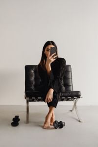 Kaboompics - Woman in Black Outfit Sitting Barefoot in a Leather Chair