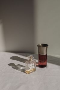 Kaboompics - Chanel No. 5 Perfume and Dom Rosa Bottle on White Fabric