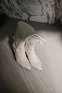 Kaboompics - White Knee-High Boots Close-Up on Neutral Floor