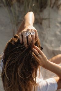 Kaboompics - Statement Rings in Windblown Hair Beach Fashion Detail