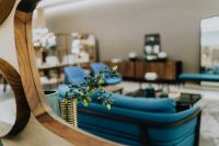 Kaboompics - Blue Sofa Reflected in Large Wooden Mirror, Modern Living Room