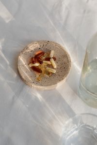 Kaboompics - Supplement Capsules in a Shell with Starfish on Sand