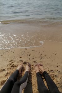 Kaboompics - Feet Stretching Toward the Sea on the Beach