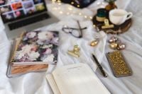 Kaboompics - Wide Work-from-Bed Workspace with Laptop, Open Organizer and Coffee on White Bedding